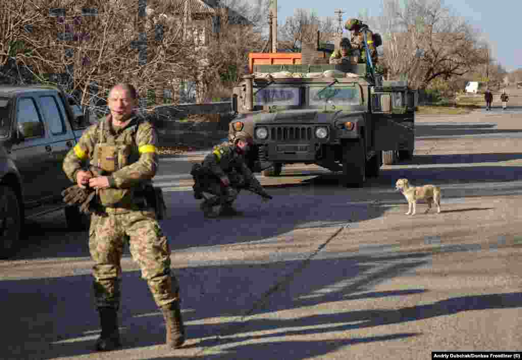 Ukrainian forces on a street in Snihurivka "People offered warm food to the military" as soldiers entered the town, Dubchak said. "I saw soldiers crying, too." 