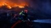 A firefighter works at the site of a warehouse heavily damaged during a Russian missile strike in Kyiv on December 29.