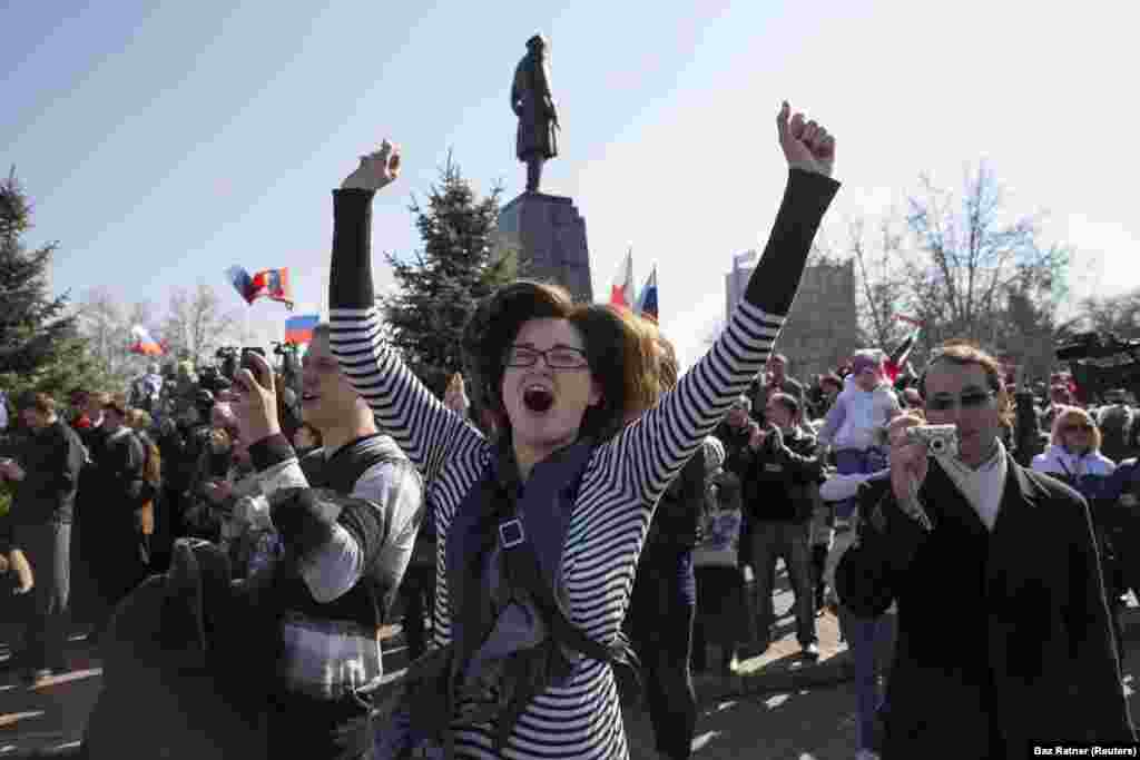 A woman celebrates in Sevastopol on March 18 as a crowd watches a live broadcast of Putin following the results of the disputed referendum. The Russian president addressed Crimeans as “citizens of Russia” during the address. 