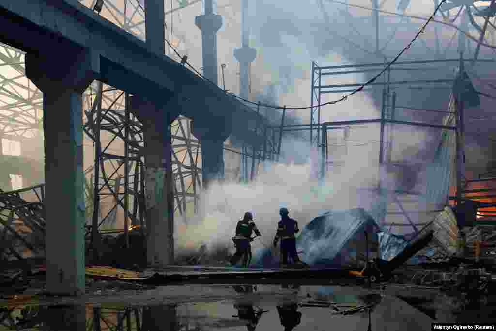 Firefighters work at the site of a heavily damaged warehouse. Ukrainian Prime Minister Denys Shmyhal called it a massive air strike that targeted social and critical infrastructure.