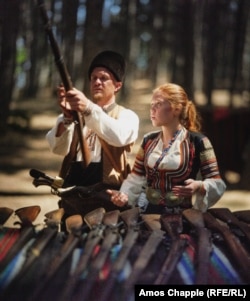 A father and daughter at a stall displaying historical weapons. Some of the guns at the stall saw action in the Russo-Turkish war and other conflicts on Bulgarian soil.