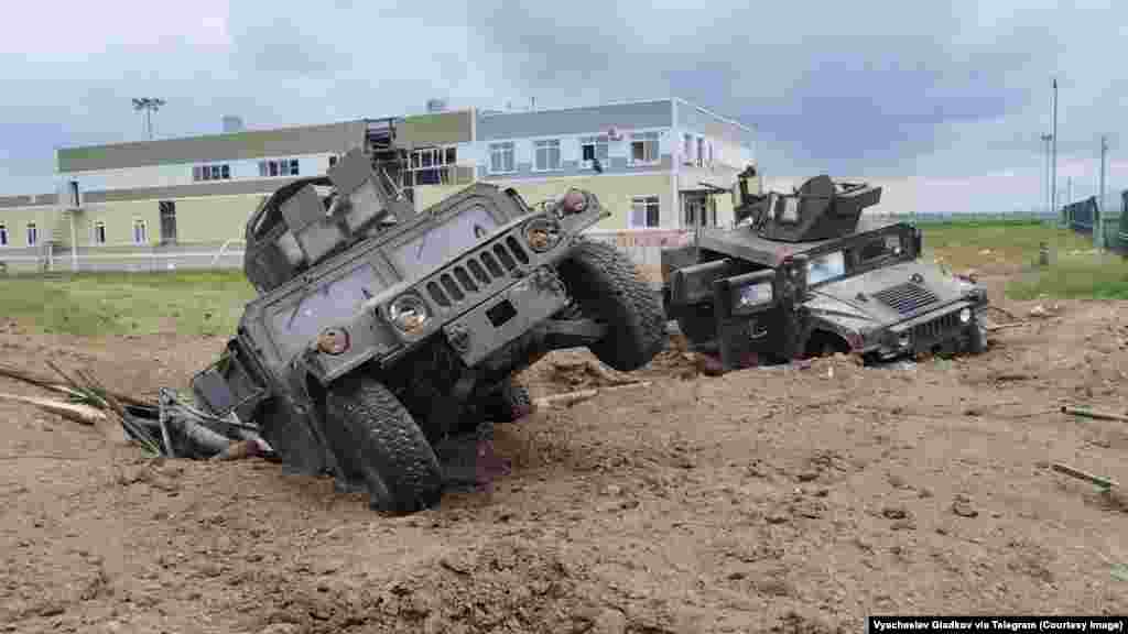 This image, showing U.S.-made Humvees in an apparent explosion crater, is from a video released by Russian authorities on May 23 after what is described as a cross-border raid into Russia's Belgorod region that began a day earlier.