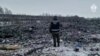 A rescue worker surveys the site of a Russian military plane crash in the Belgorod region on January 24.