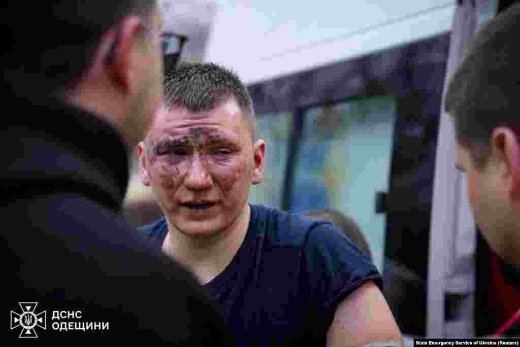An injured rescuer is attended to by his colleagues following the Russian missile strike. The tactic of firing a second missile at the same location, aiming to hit rescuers, is known in military terms as a double tap. Such strikes often hit civilians. 