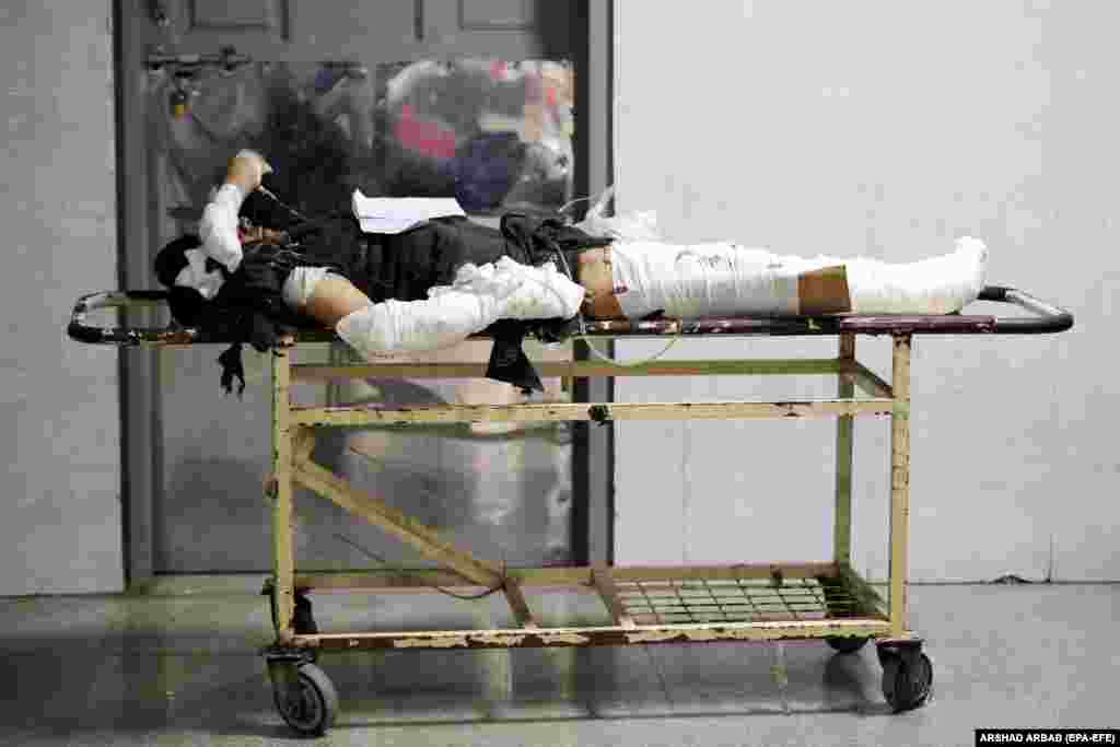 ...as an injured man lies on a stretcher at the hospital. 