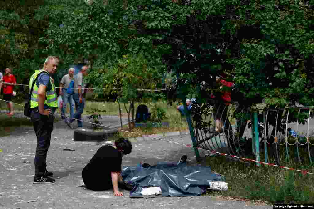 A woman sits next to the bodies of her relatives killed during the missile attack. Russian forces have repeatedly targeted the capital with massive barrages since Moscow began its full-scale invasion in February 2022. The last major attack on Kyiv with drones and missiles was last month. 