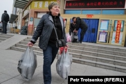 A woman walks with full shopping bags in Khorgos.