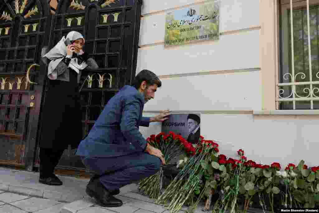 Flowers and a card that reads, "We mourn" are left near the Iranian Embassy in Moscow. Russian President Vladimir Putin praised Raisi as an "outstanding politician," and "a true friend of Russia."