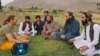 A German tourist talks to local residents and Taliban officials in the northern province of Panjshir.