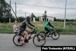 Children ride bicycles in the village of Ozernoye, where the descendants of Poles exiled to Kazakhstan live.