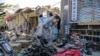 People gather at the scene of a previous blast in Kabul's Dasht-e Barchi area. (file photo)
