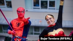 Dy vullnetarë nga Klubi Alpin Prishtina, të veshur me kostumet e superheronjve Spiderman dhe Superwoman.