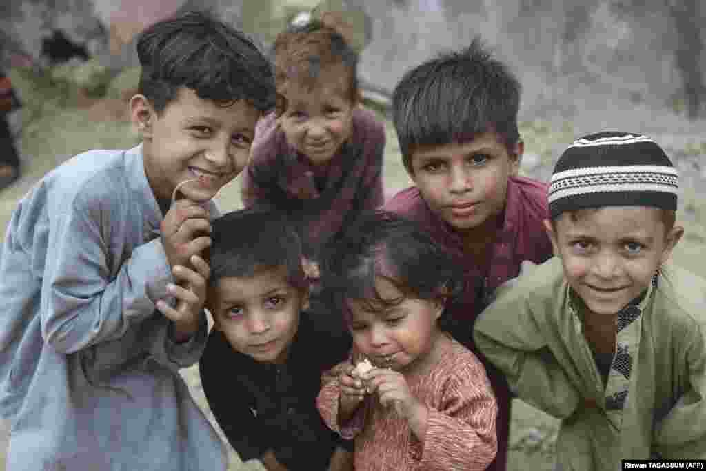 Afghan children pose for a photo at an Afghan refugee camp in Karachi on September 21. Local media reported that the caretaker government in Islamabad approved the move on September 26 to repatriate over 1.1 million Afghan nationals living illegally in the country back to Afghanistan. However, no official confirmation has been released from the interim government. 