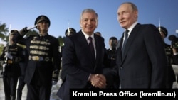 Uzbek President Shavkat Mirziyoev (left) welcomes Russian President Vladimir Putin at Tashkent's airport in May. 