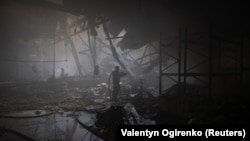 A firefighter works at the site where a printing press was hit by Russian missile strikes in Kharkiv, Ukraine, on May 23.