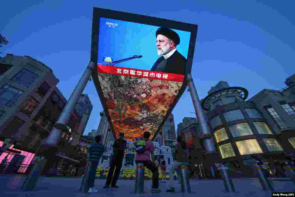 Pedestrians in Beijing watch a large screen showing footage of Raisi announcing the news of his death. Chinese President Xi Jinping called Raisi's death "tragic" and said that "the Chinese people have lost a good friend," a spokesman for China's Foreign Ministry said. 