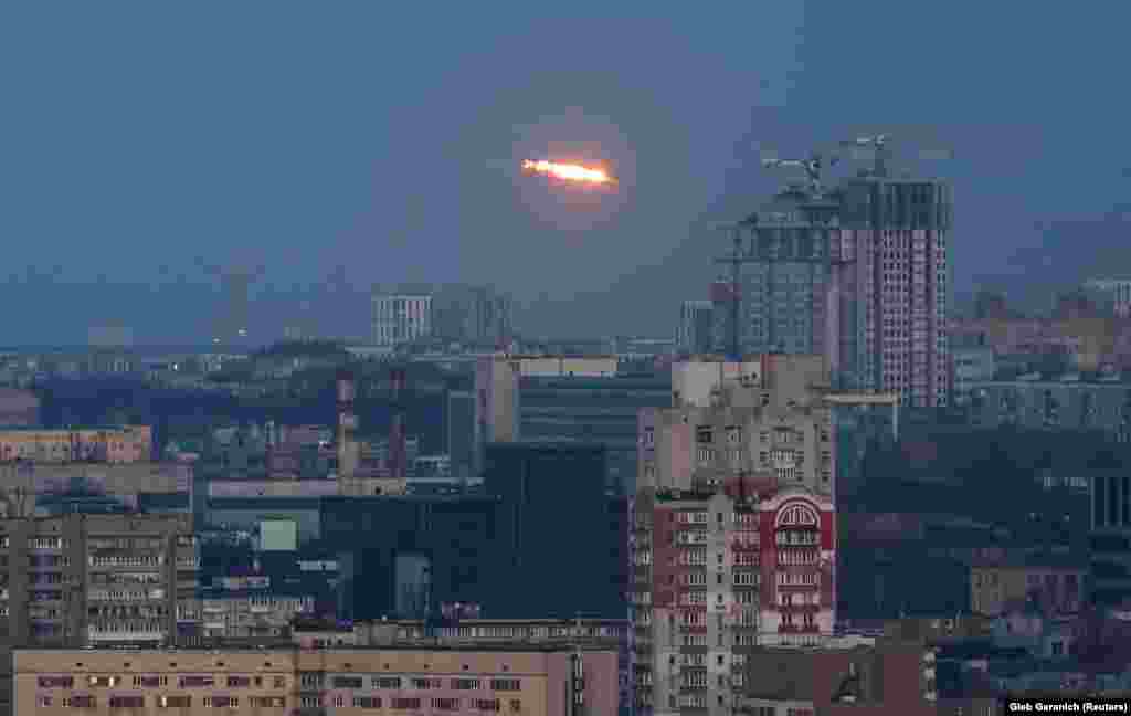 An explosion from a missile is seen above the city of Kyiv. Ukraine's prosecutor general said the latest wave of Russian strikes had killed at least 16 people and injured almost 100. 
