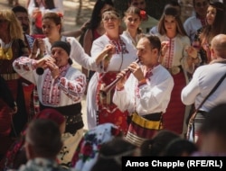 Musicians play in the center of a circle of dancers.