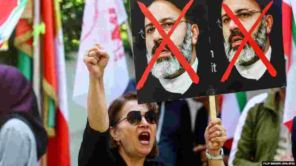 An anti-government protester holds a placard of Raisi in front of the Iranian Embassy in Berlin. Raisi was dubbed the "Butcher of Tehran" for his role as one of the judges who oversaw the executions of thousands of political prisoners in the late 1980s.