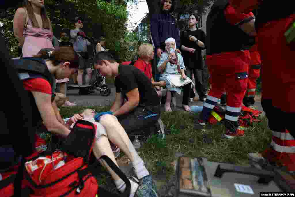 First responders tend to the wounded at the residential area. The Russian Defense Ministry said allegations by Kyiv that it had deliberately targeted civilian infrastructure in the strike were "absolutely untrue."