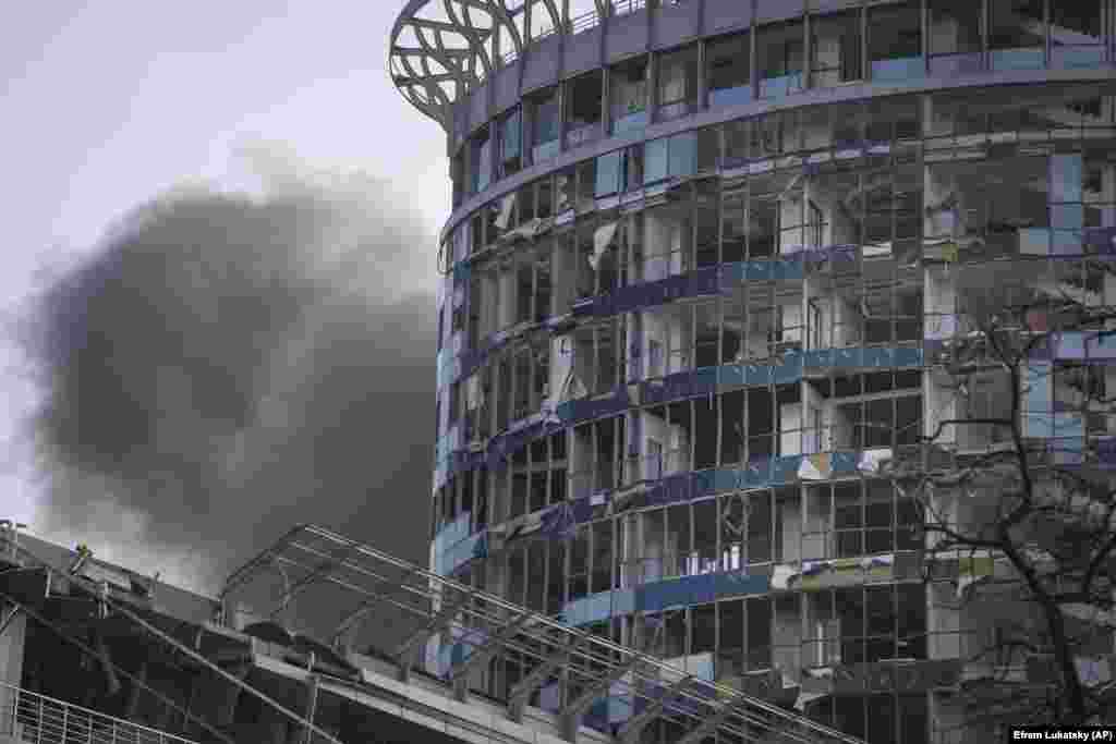 Smoke rises behind a shattered building in Kyiv. "This morning, the enemy fired over 150 missiles and attack drones at peaceful Ukrainian cities. We know about 16 dead. 97 wounded, including at least two children aged 6 and 8 years old," Prosecutor-General Andriy Kostin said on social media.