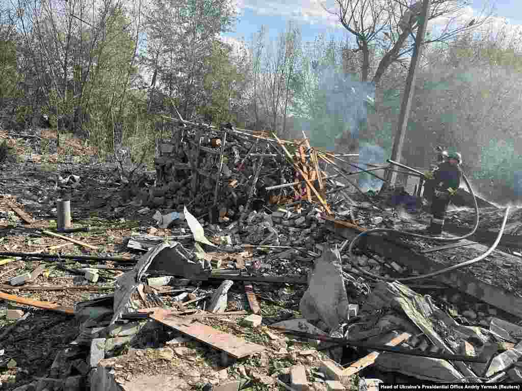 Firefighters work at the site of the missile strike. Kharkiv regional Governor Oleh Synyehubov said that a cafe and a shop had been hit at around lunchtime in the village of Hroza in the Kupyansk district of Kharkiv and that many civilians had been there at the time.
