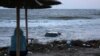 A woman looks at a car floating in the sea in the town of Tsarevo, on Bulgaria&#39;s Black Sea coast. on September 6.<br />
<br />
At least two men have died, and a search for a mother and child continues following <a href="https://d248ijkgwbbf5u.cloudfront.net/a/dvama-muzhe-zaginali-pri-navodneniata-carevo/32580506.html" target="_self">torrential rains</a> that caused widespread flooding in the region.