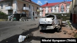 Buildings and a vehicle damaged from attacks in Shebekino earlier this month.