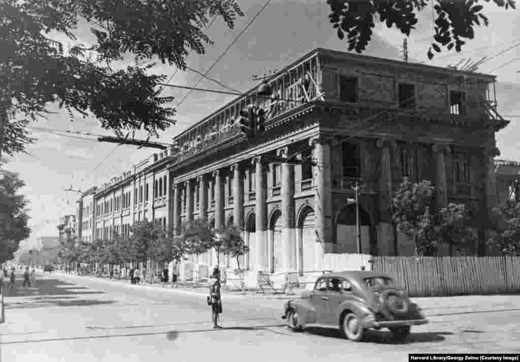 A building undergoes reconstruction in the city known today as Donetsk, soon after the Soviet Red Army recaptured the Donbas region from Nazi-led forces during World War II. Donetsk was known as Stalino from 1924 until 1961. This photo is one of several held in the Harvard Library image archive that shows the postwar rebuilding of Ukraine's eastern Donbas region through the 1940s. 