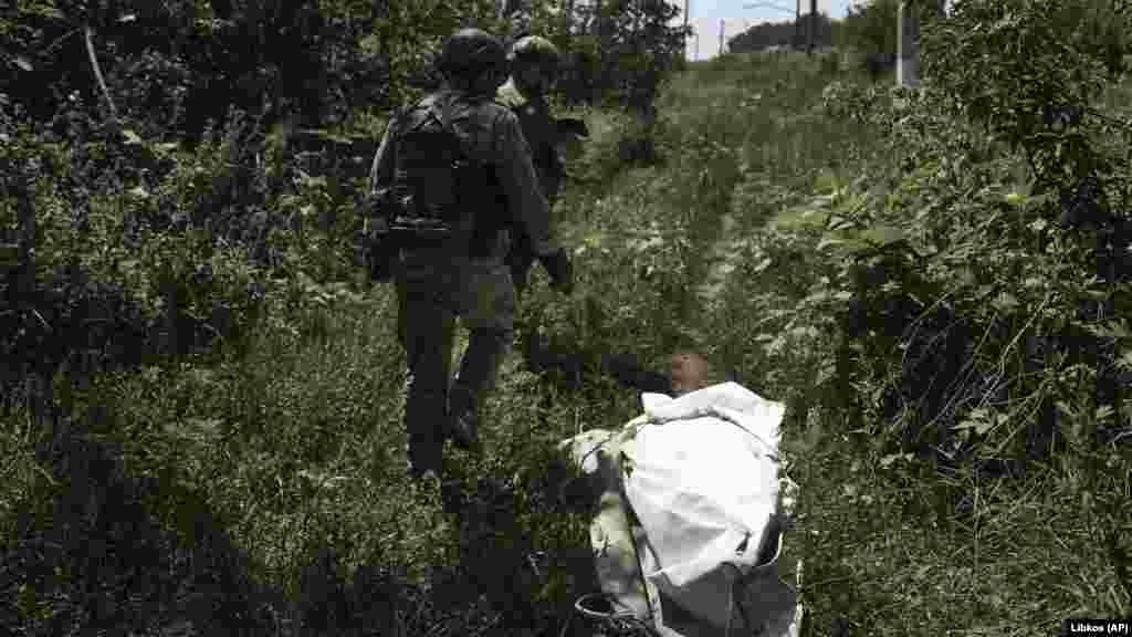 Ukrainian soldiers walk on the front line near Bakhmut. 