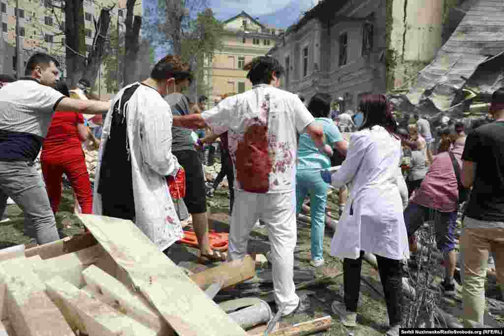 People remove rubble as they search for survivors at the children's hospital. Kyiv Mayor Vitaliy Klitschko told Reuters that the attack was "one of the worst" on the city in the 28-month-old full-scale war.