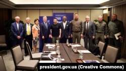 Ukrainian President Volodymyr Zelenskiy (center) poses with the bipartisan U.S. congressional delegation in Singapore on June 1.