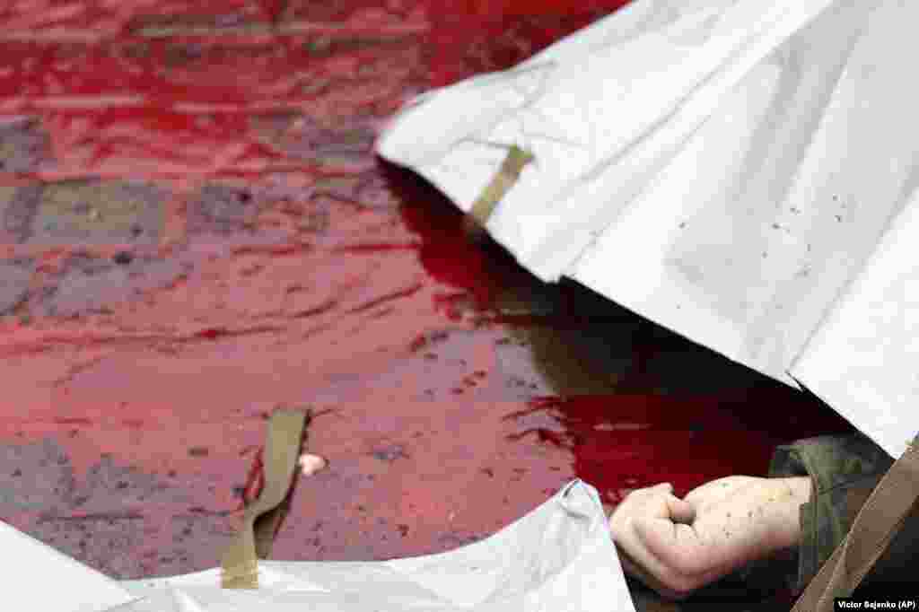 An Associated Press photographer who arrived later on the scene photographed the hand of a victim in a pool of blood.&nbsp; Officials said dozens of other people were wounded in the attack that struck houses in the port city.