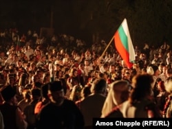 A man holds a Bulgarian flag ahead of the bonfire lighting on August 19.