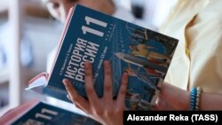Students look through copies of a new Russian history textbook at Secondary School No. 56 in the city of Shchastye. The textbook, authored by Russian presidential aide Vladimir Medinsky, has been criticized for emulating Soviet practices of ideological indoctrination. 