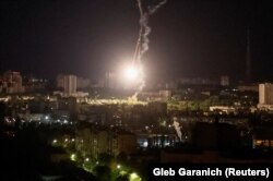 The explosion of an intercepted missile is seen in the sky over Kyiv during a Russian missile strike on May 16.
