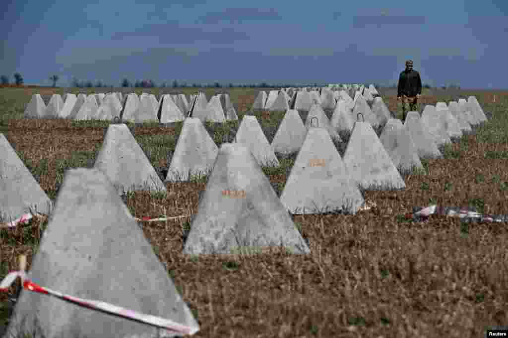 Pyramidal anti-tank obstacles known as "dragon's teeth" are inspected before being installed. The Wall Street Journal reported on March 7 that Ukrainian troops are building the fortifications in expectation of a Russian offensive in the spring, though there are worries that the progress is not fast enough. 