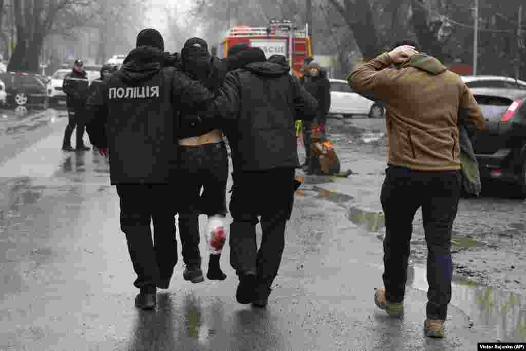 An injured man is escorted from the scene. Nearly 25 months into Russia's full-scale invasion of Ukraine, Moscow repeatedly denies it is targeting civilians.