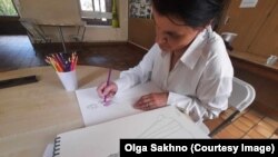 Sakhno at work on her designs