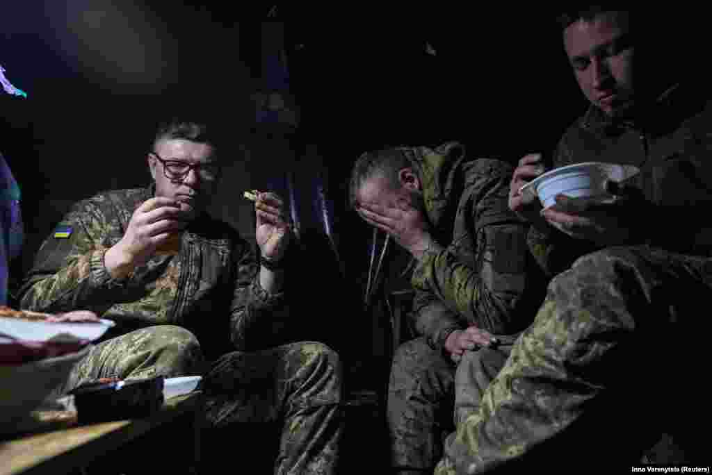 Soldiers eat and rest in their dugout. “Sure, everyone is tired of war, physically and mentally. But imagine if we stop — what happens next?” Serhiy added. 
