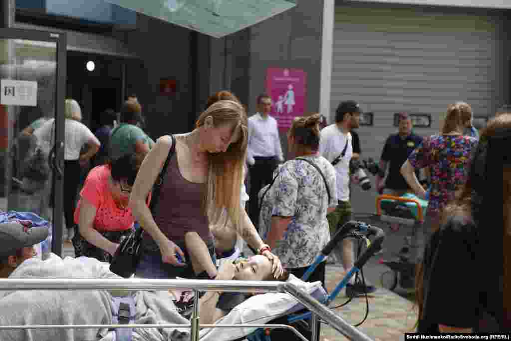 A woman comforts a child outside the damaged hospital. It was not immediately clear if there were fatalities at the site. 