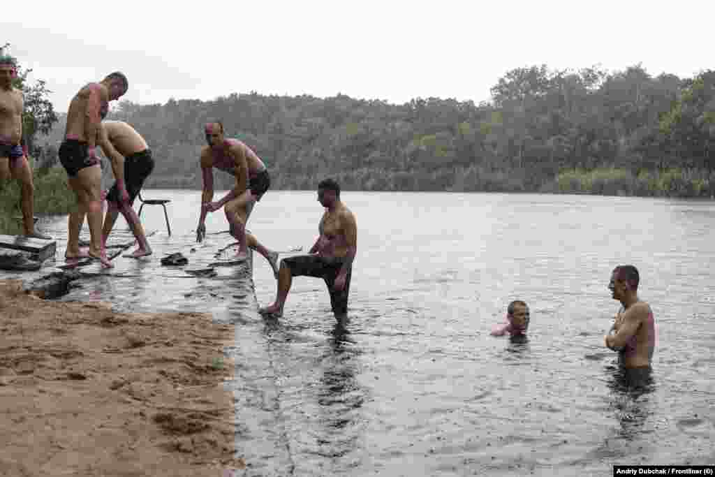 The new recruits take a swim on a Sunday, their only day for rest and recreation. Ukrainian officials have emphasized that, unlike Russia's recruitment of convicts for the notorious Wagner mercenary group, where they were thrust into the deadliest battles, Ukraine's program aims to integrate convicts into regular frontline units.