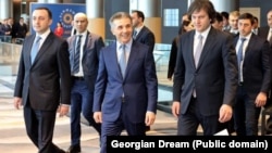 Georgian Dream Chairman Irakli Garibashvili (left), influential billionaire founder Bidzina Ivanishvili (center), and Prime Minister Irakli Kobakhidze (right) attend the party's congress in Tbilisi in February.