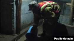A Kyrgyz man clears water from a flooded house in Jalal-Abbad on April 21.
