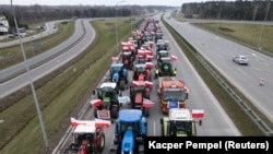A drone view of farmers' tractors blocking a speedway from Lublin to Warsaw as they protest against the European Union's Green Deal and imports of Ukrainian agricultural products, on the outskirts of Warsaw in Wiazowna, Poland, on March 6.