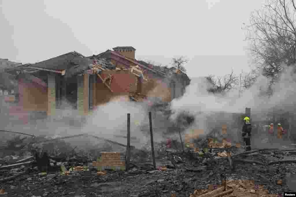 A rescuer stands in a residential area hit by a Russian missile. At least 10 houses in Odesa and some emergency service equipment were damaged in the attack, which started a blaze, according to Ukraine’s Emergency Service and Regional Governor Oleh Kiper. 