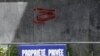 Graffiti depicting a coffin and the words "French soldiers in Ukraine" is seen behind a fence reading "Private Property" in Paris.