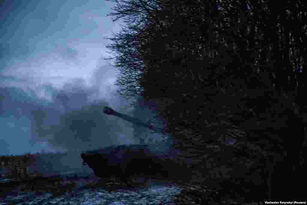 A cloud of smoke emanates from the gun after a shell is launched toward Russian positions. 