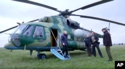 In a photo released on April 18, Russian President Vladimir Putin arrives at an undisclosed location on a tour of Ukrainian territories occupied by Moscow's invading forces.