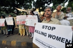 Pakistani human rights activists hold a protest in the southern seaport city of Karachi to protest the killing of women.
